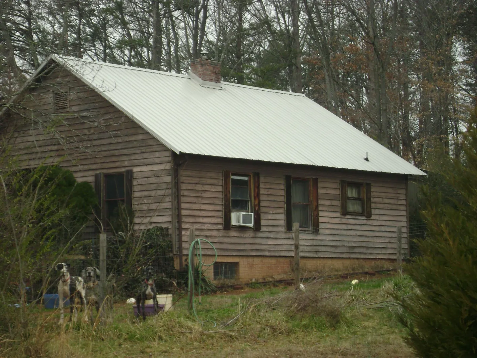 White metal roof on an old wood sided farmhouse, from a Asphalt Shingle Roof Repair job in Norcross